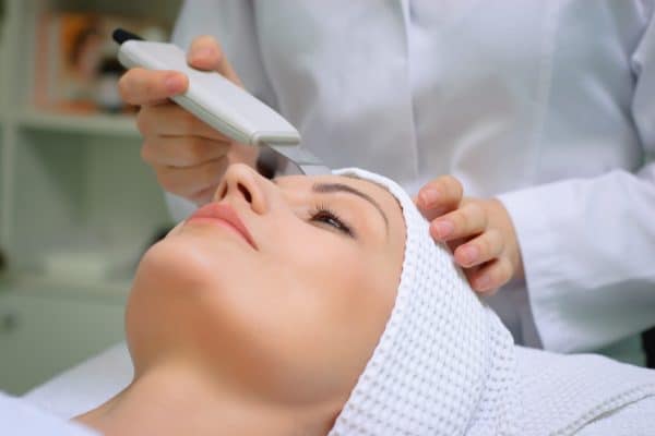 A woman at beauty spa getting facial treatment with ultrasonic facial cleaning | Synergy Wellness MediSpa in Red Bank, NJ