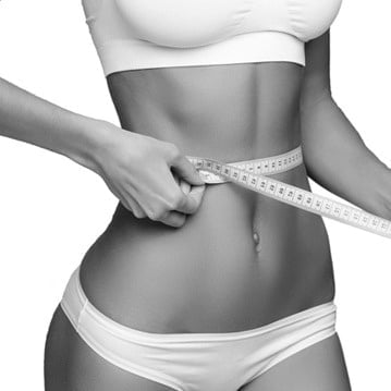 Thin Woman Measuring her Waistline with Measure Tape | Synergy Wellness MediSpa in Red Bank, NJ
