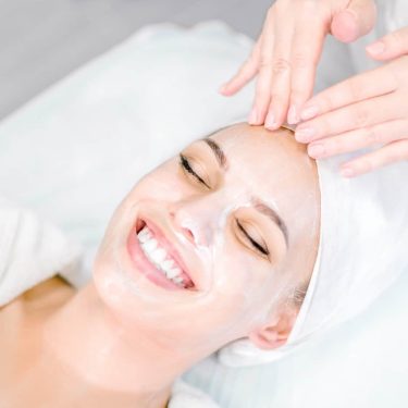 a woman receiving a facial massage