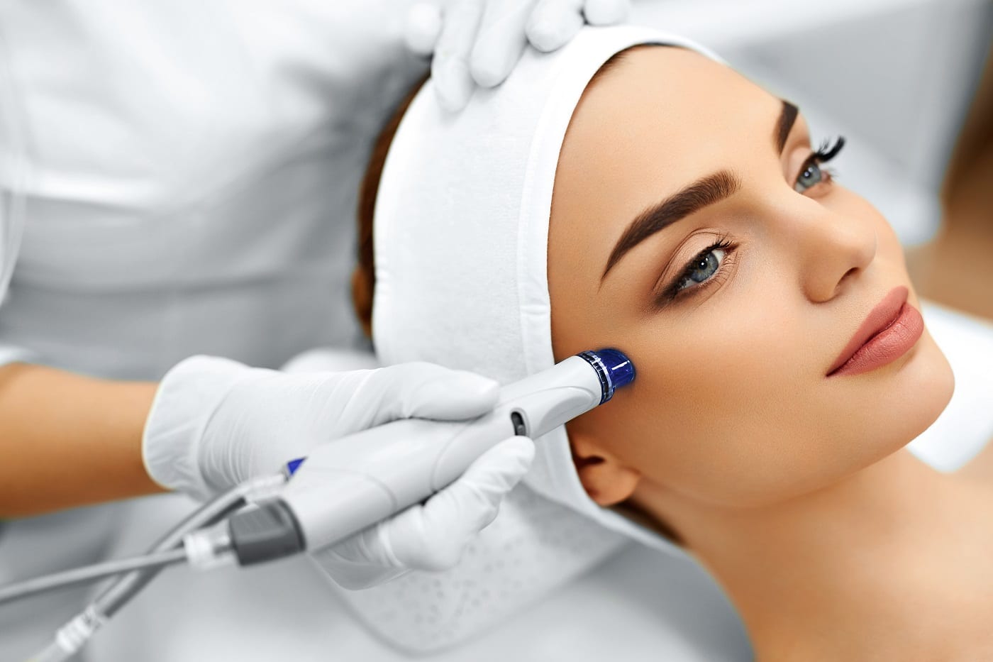 A woman getting a face massage - Exosomes Treatment by Synergy Wellness | Oceanport, NJ
